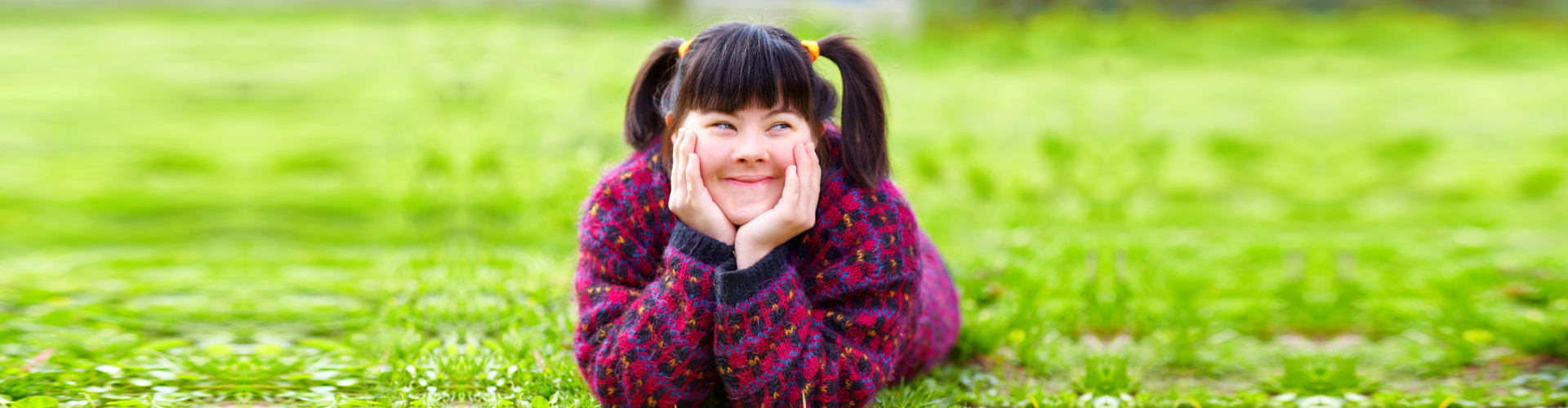 happy young girl with disability on spring lawn