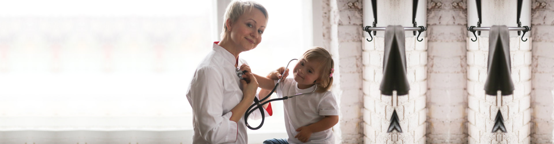 Cardiologist listens to the heart of a child